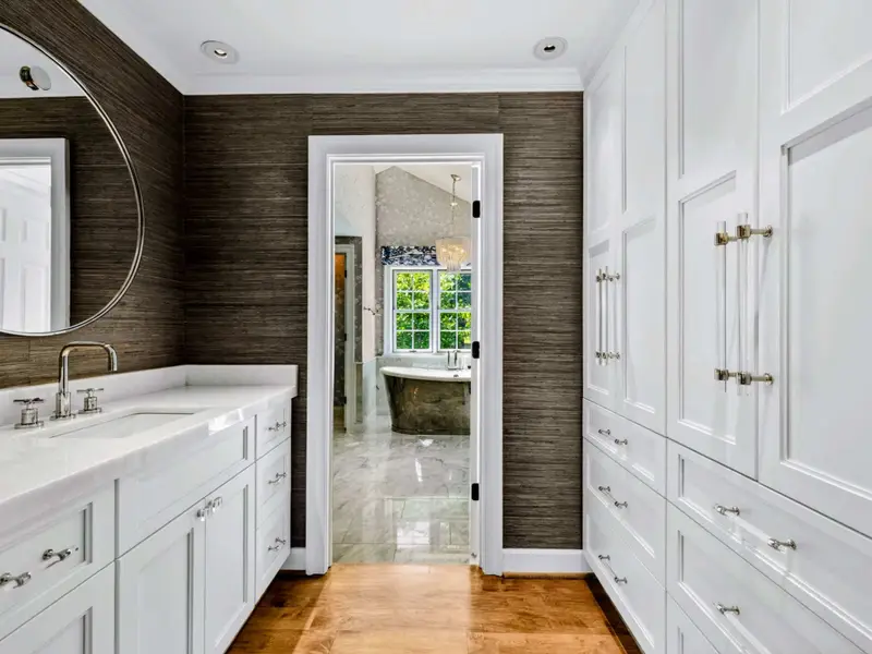 Primary Suite - View toward the primary bath through the connected dressing area.