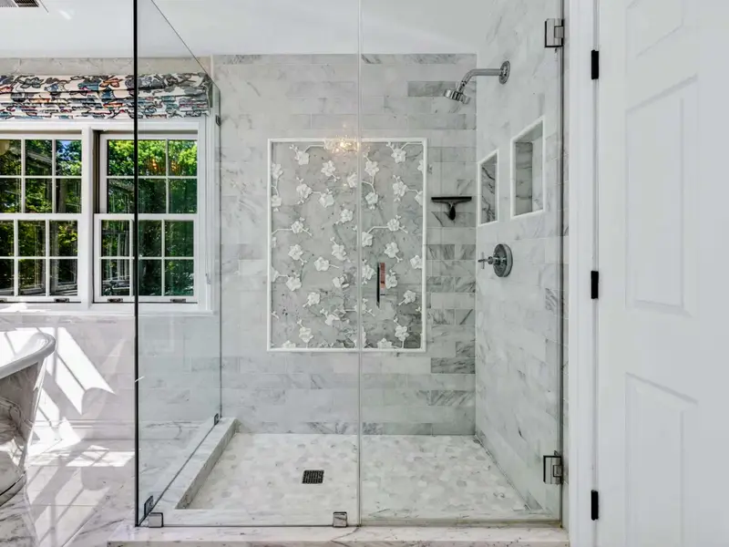 Primary Bath - Marble walk-in shower with detailed tile niche.