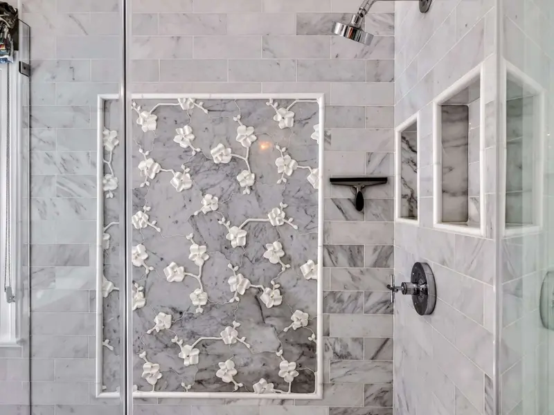 Primary Bath - Walk-in shower with stone and tile detail.
