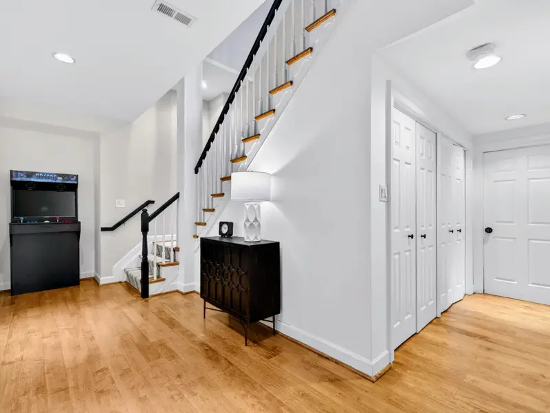 Lower Hallway - The lower-level circulation, with the laundry and bedrooms just beyond.