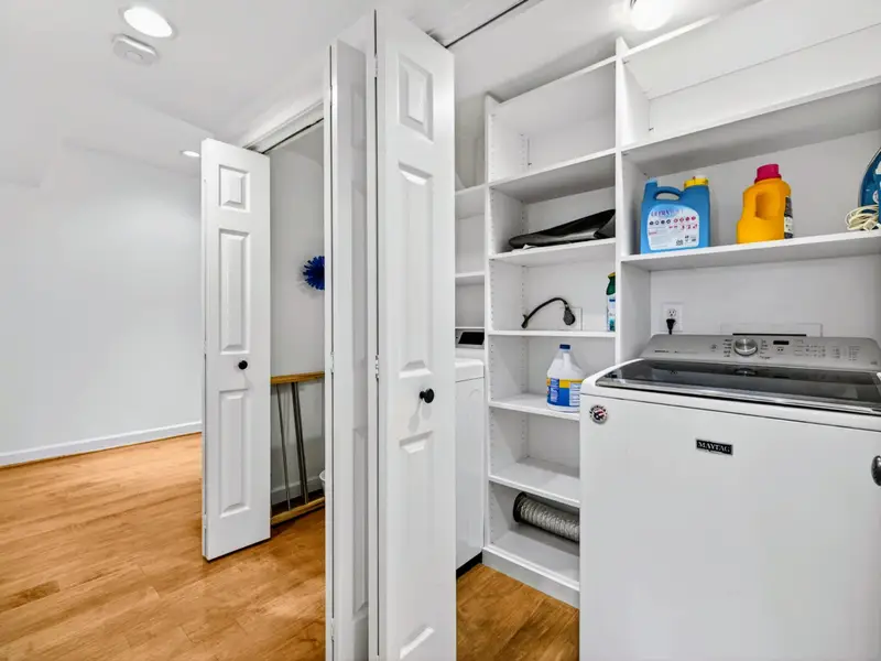 Laundry Room - Tucked-away laundry with washer, dryer, and built-in shelving.