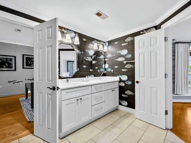 Jack-and-Jill Bath - Playful fish wallpaper makes this lower-level bath the favorite of the kids.