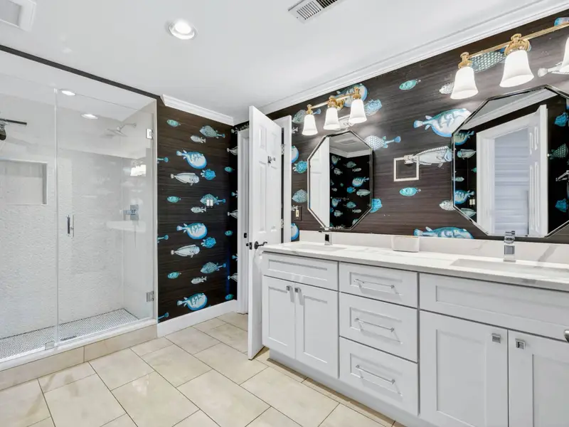 Jack-and-Jill Bath - Detail of the playful fish wallpaper and octagon mirror.