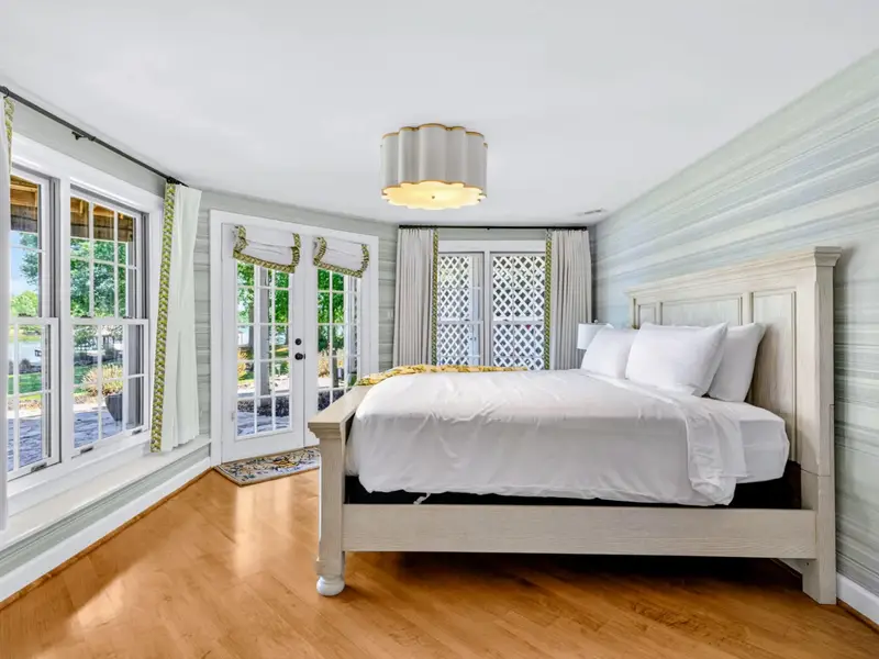 King Bedroom - French doors flood this king bedroom with natural light.