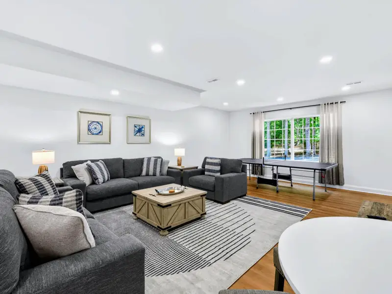 Family Room - Lower-level family room with deep sectional and wall-mounted TV for movie nights.