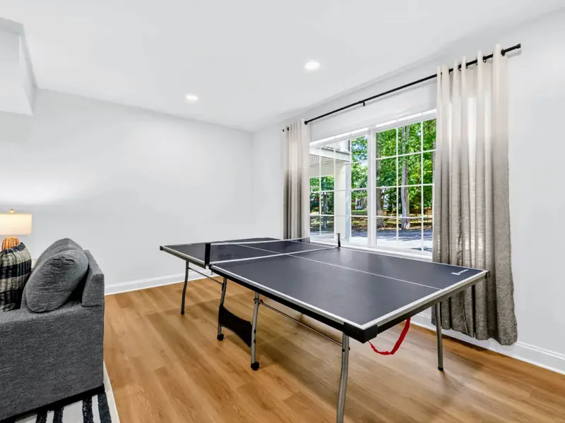 Game Room - Ping pong with a wall of windows looking out to the deck just beyond.