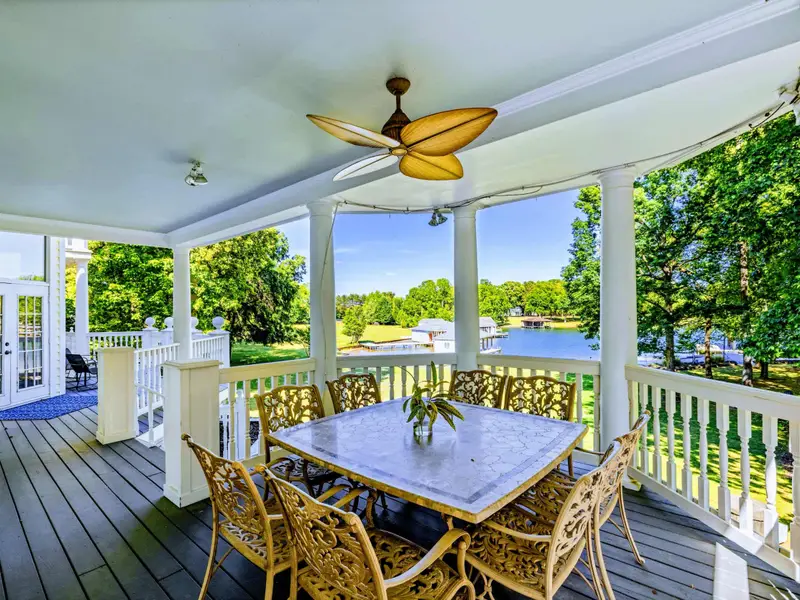 Deck - Long covered porch with seating along its full length, ceiling fans overhead.