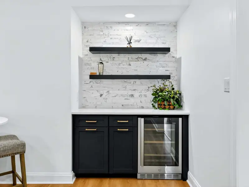 Bar - The lower-level bar with built-in fridge and styled shelving.