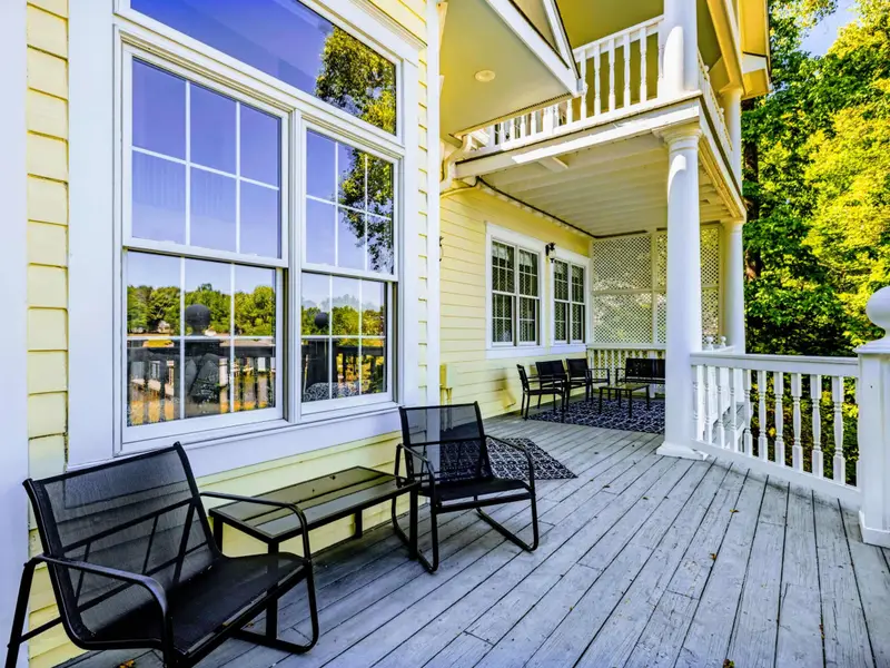 Deck - Comfortable seating along the deep covered porch, all facing the water.