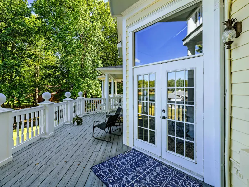 Deck - The porch wraps around the back of the house, giving multiple seating zones.