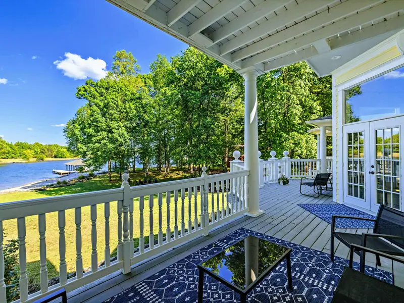 Deck - Looking down the length of the covered porch with the lake just beyond the railing.