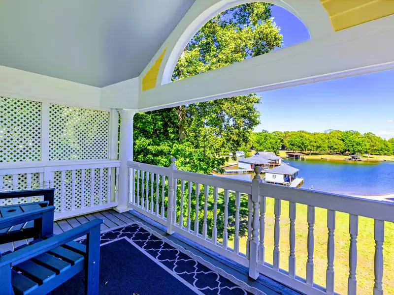 Deck - Upper-level balcony with comfortable seating and an unobstructed water view.