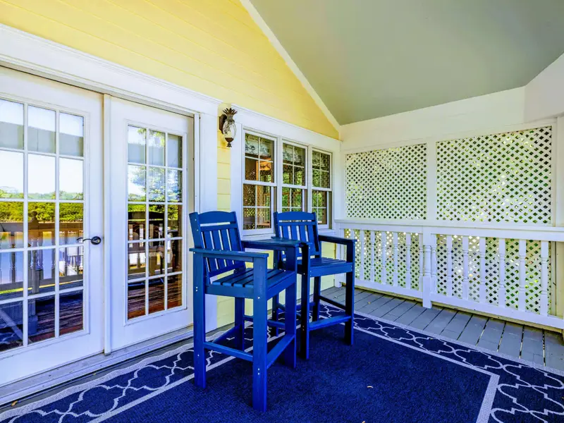 Deck - Adirondack chairs on the upper balcony with the lake in the background.