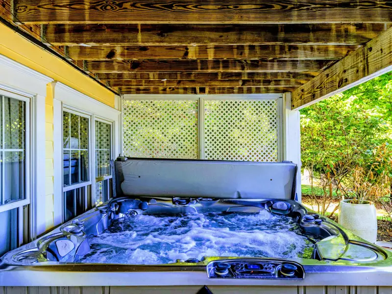 Hot Tub - Covered hot tub off the lower deck for an evening soak with lake views.