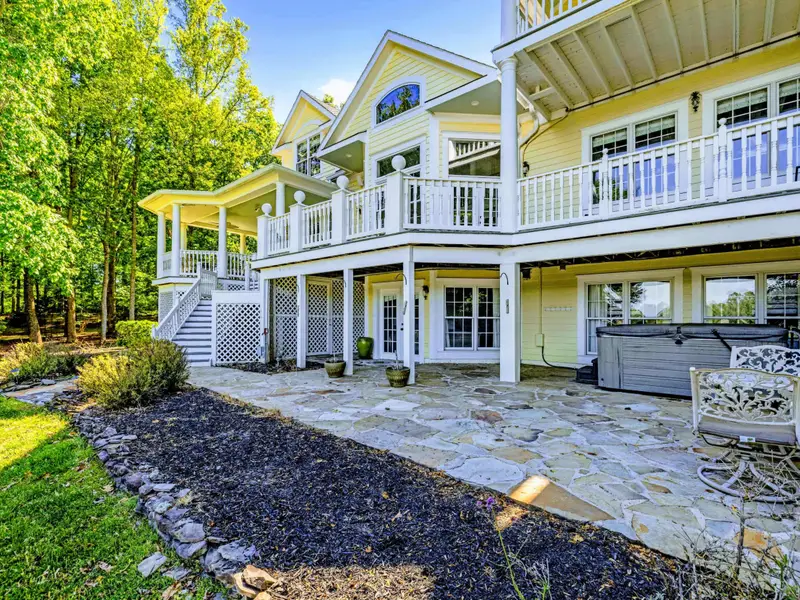 From Above - The full back of the home showing decks, porches, and lake-facing windows.