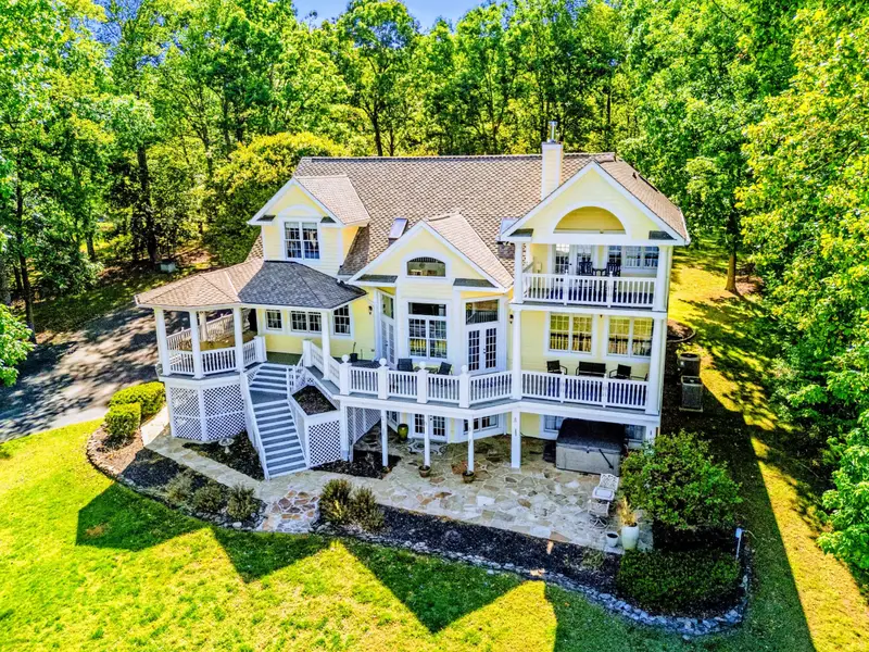 From Above - Closer aerial of the back porch, balcony, and yard down to the cove.