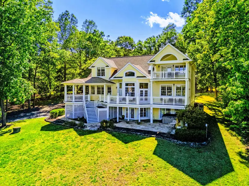 Exterior - Side view of the home showing the tiered back porches and yard.