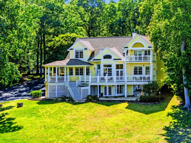 From Above - Wide-angle aerial of the home's full lake-facing facade.