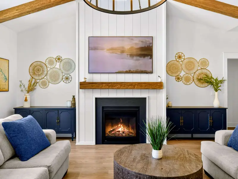 Cozy Up - The Smart TV and gas fireplace anchor a shiplap wall flanked by navy consoles and woven art, set for easy evenings in.