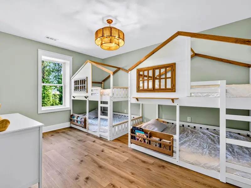 Treehouse Bunk Room - Two whimsical treehouse bunks sleep four kids under a rattan chandelier, the room they will never want to leave.