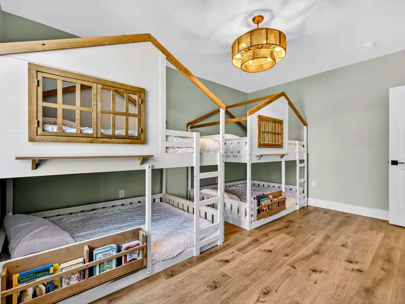 Treehouse Bunks - Built-in book nooks and playful peaked roofs give the lower-level bunk room serious kid appeal.
