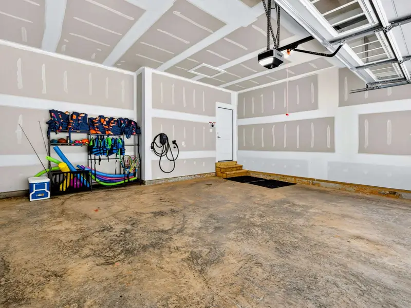 Garage - The two-car garage holds the gear rack of life jackets and pool toys, plus a Level 2 EV charger for your car.