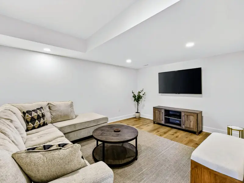Media Lounge - A deep sectional faces a big-screen Smart TV in the lower-level media room, the natural gathering spot for movie nights.