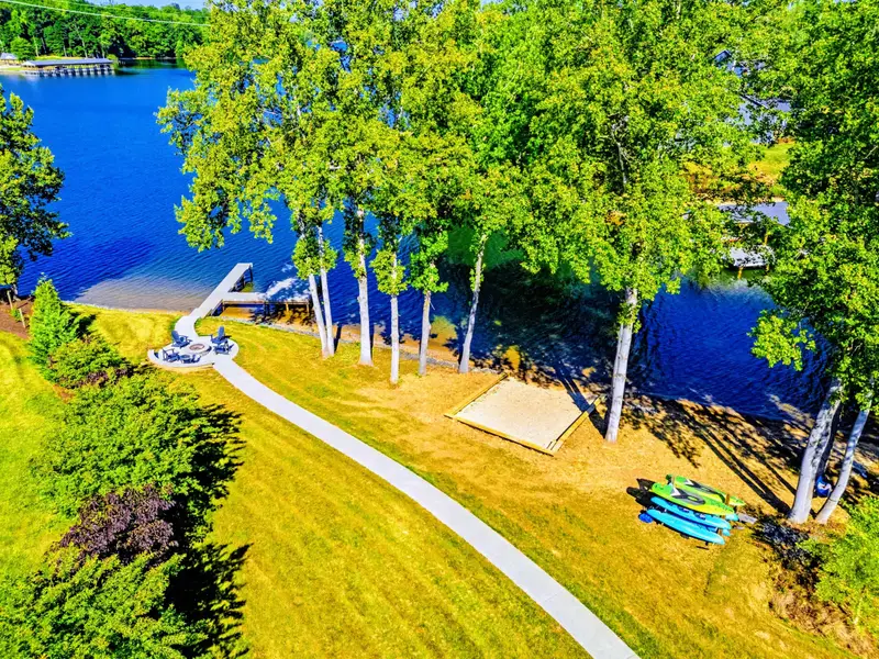 Backyard from Above - Bright kayaks waiting at the shore, the dock just beyond, and a clean shot of the lake everyone came for.