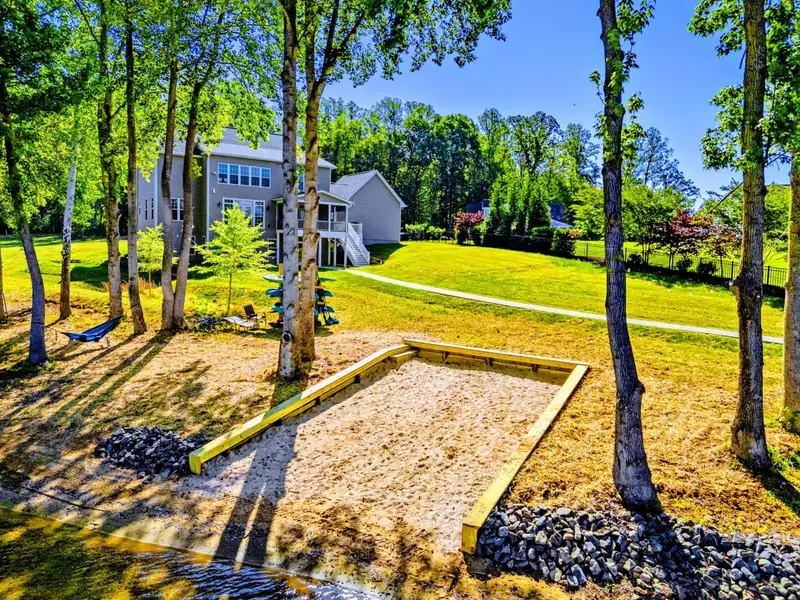Yard to Beach - A wide green lawn drops down to the sandy beach, with room for games, gatherings, and easy lake days.
