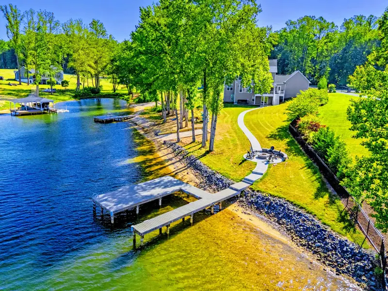 From Above - The full property in a single frame: private dock, sandy beach, fire pit, and quiet cove out front.