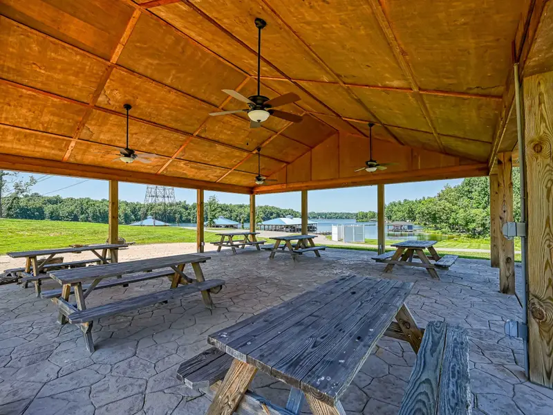 Elk Creek Landing Gazebo - Wood-ceilinged pavilion with ceiling fans and multiple picnic tables, the lake just steps away for casual lakeside meals.