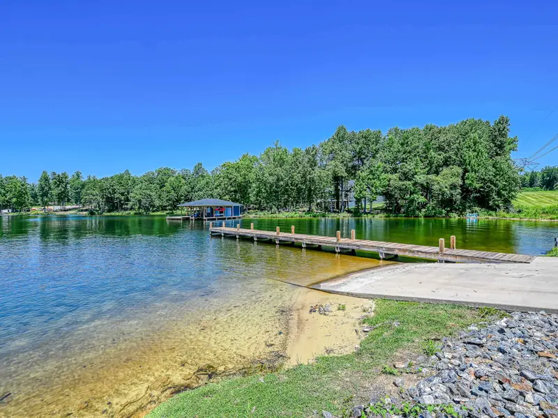 Elk Creek Landing Boat Ramp - Lake view from the launch with the shoreline curving toward the boathouses across the cove.