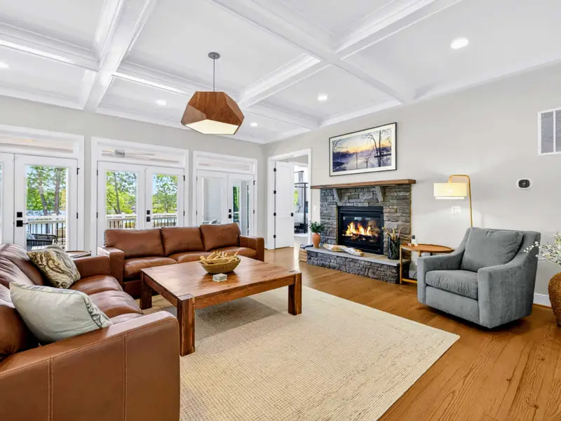 Great Room - A wall-mounted Frame TV and leather sofas keep everyone together by the lake windows.