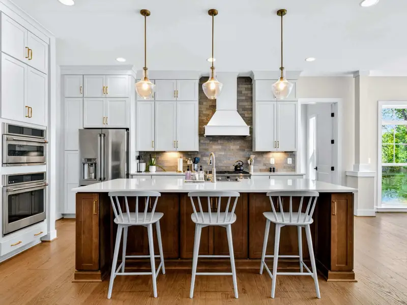 Kitchen - Counter stools at the navy island keep everyone in on the group meal and the lake views.