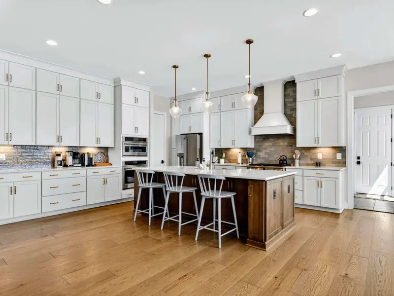 Chef's Kitchen - The oversized island seats three with the range and pantry close at hand.