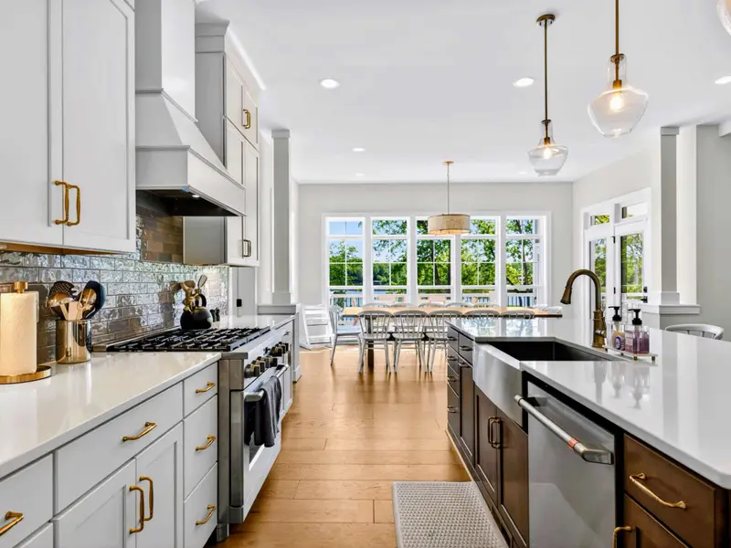 Kitchen - A prep sink in the island and a farmhouse sink face the windows, so you never miss the view.