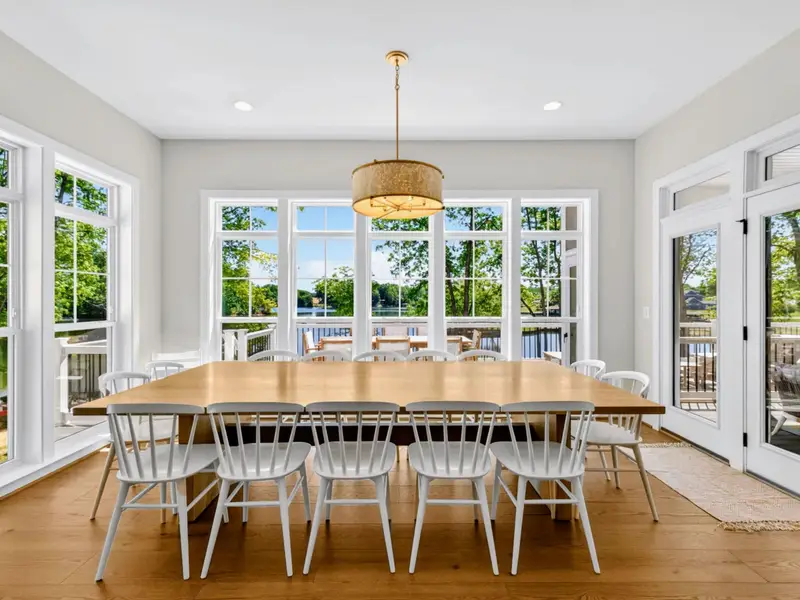 Dining Area - A custom extra-large table seats 14 under pendant lighting, set for group dinners.