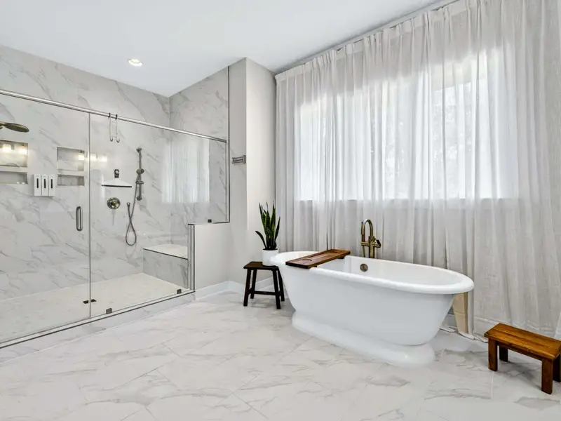 Primary Bath - Dual vanities, a soaking tub, and a large walk-in shower fill the spa-style bath.