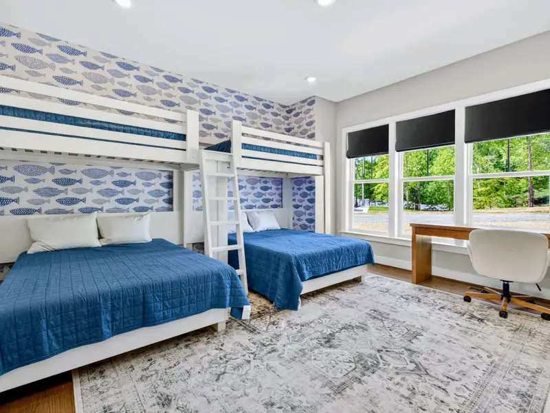 Bunk Room - Blue-bedded bunks for extra guests, connected to the primary suite through the bathroom.