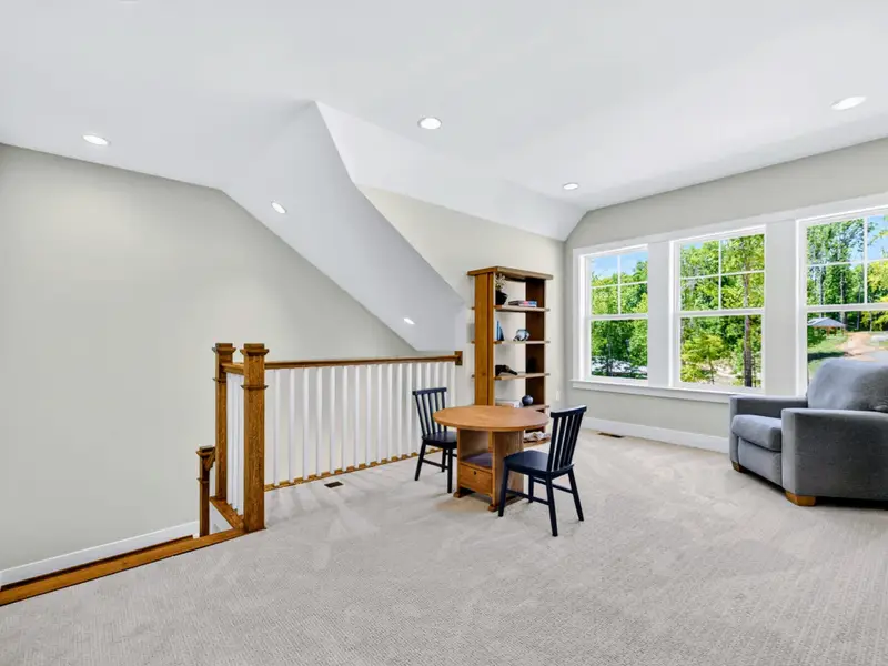 Loft - Bookshelves, a recliner, and a kids' table make the loft a bright bonus hangout.