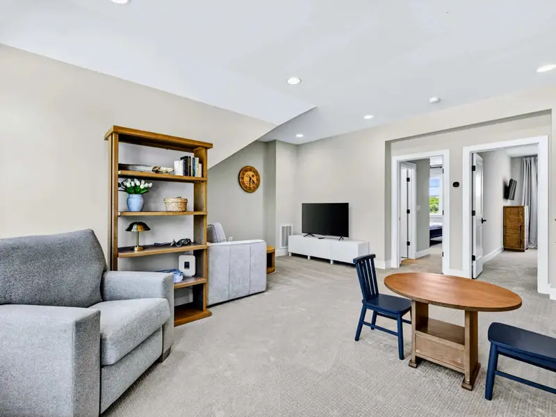 Loft - The full loft: a sofa, TV, and a kids' table by the windows.