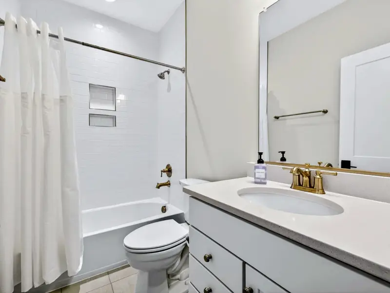 Full Bathroom - A tub-and-shower combo beside a single vanity in the upstairs bath.