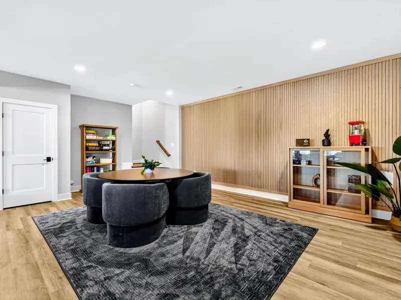 Lower-Level Lounge - Deep seating and a rug make a second living room, with a bookshelf of board games for all ages.