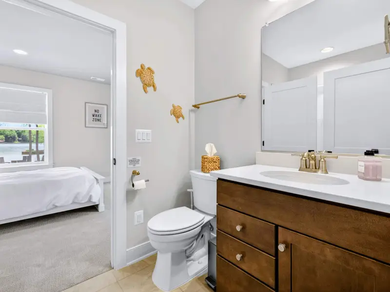 Full Bathroom - A basement bath with a tub-shower combo, opening to both the bedroom and the hallway.