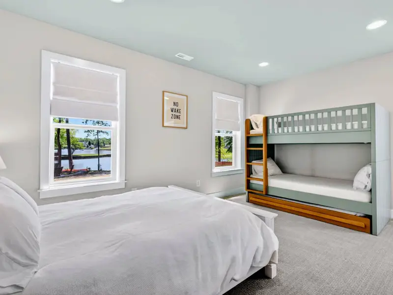 Bunk Room - A queen bed and a twin bunk with trundle share this flexible basement bedroom with lake views.
