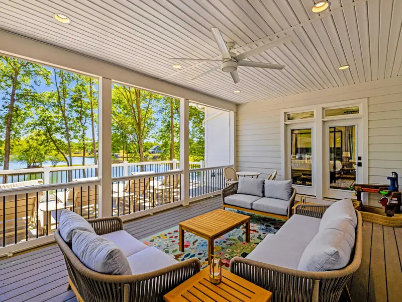 Screened Porch - Teak sofas and a ceiling fan make a bug-free perch over the water.
