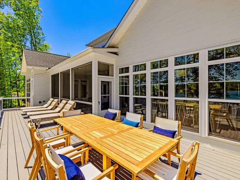 Sun Deck - Polywood loungers line the open deck with lake views, the teak dining table just steps away.
