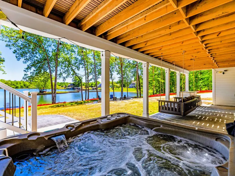 Hot Tub - Sink into the frothing spa while taking in open water views through the trees, sheltered beneath the beamed lower patio.