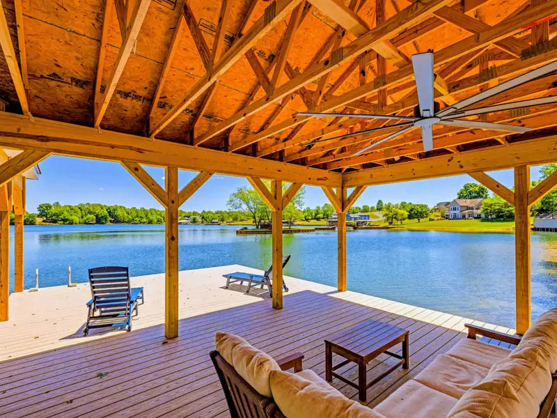Dock & Boathouse - Relax on the sectional sofa beneath the boathouse rafters, the dock and lake stretching out toward the shoreline.