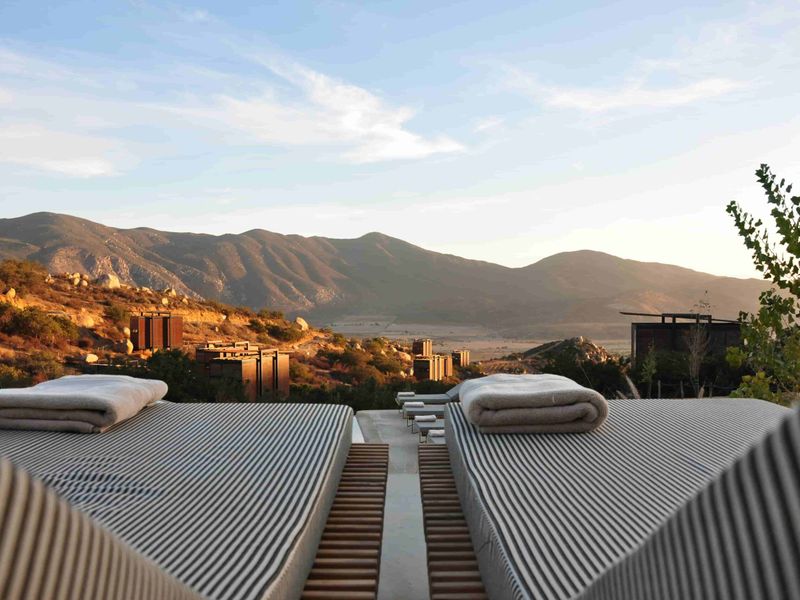 a group of beds with a view of mountains in the background